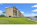 Exterior view of the condo on a lush green lawn near the waterfront on a beautiful bright day at 265 Venice Way # I-402, Myrtle Beach, SC 29577