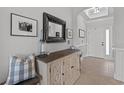 Welcoming foyer with a decorative mirror, console table, art, and a neutral color palette at 265 Venice Way # I-402, Myrtle Beach, SC 29577
