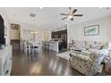 Open-concept living room features hardwood floors, a ceiling fan and flows into the kitchen and dining area at 2794 Howard Ave. # D, Myrtle Beach, SC 29577