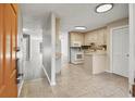 Entering the kitchen that features neutral tones, tile floors, white appliances, and plenty of storage space at 306 74Th Ave. N # 105, Myrtle Beach, SC 29572