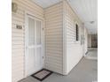 Condo exterior entrance with a white door and siding at 3308 S Ocean Blvd. # 2-A, North Myrtle Beach, SC 29582