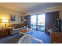 Inviting living room with a sliding glass door leading to a balcony and comfortable seating at 415 Ocean Creek Blvd. # 2333, Myrtle Beach, SC 29572