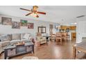 Comfortable living room featuring a large sofa, ceiling fan, wood floors and a view of the eat-in kitchen at 4293 Parkway Ln. # 34, Little River, SC 29566