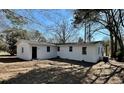 View of the home's back exterior, showcasing the yard and access points at 512 W Baptist St., Marion, SC 29571