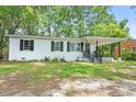 Charming single-story home featuring a covered porch and well-maintained front yard at 512 W Baptist St., Marion, SC 29571