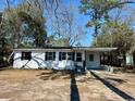 Inviting single-story home with black shutters and a convenient carport at 512 W Baptist St., Marion, SC 29571