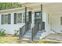 Welcoming front porch with gray stairs and a black railing, offering a cozy entrance at 512 W Baptist St., Marion, SC 29571
