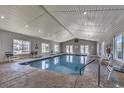 Inviting indoor pool area with natural lighting, comfortable seating, and pristine blue water at 602 Waterway Village Blvd. # 30-F, Myrtle Beach, SC 29579