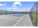 Outdoor tennis court features net, bright blue flooring, and surrounding greenery creating an active community space at 602 Waterway Village Blvd. # 30-F, Myrtle Beach, SC 29579