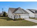 Well-maintained one-story home featuring a charming front porch and a two-car attached garage at 617 Cherry Blossom Dr., Murrells Inlet, SC 29576