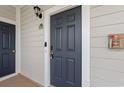 Close-up of a unit's dark blue front door with hardware and adjacent emergency equipment box at 6253 Catalina Dr. # 921, North Myrtle Beach, SC 29582