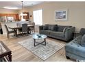 Cozy open-concept living room with modern furniture, adjacent dining area, and laminate flooring at 6253 Catalina Dr. # 921, North Myrtle Beach, SC 29582