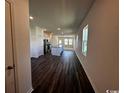 Open floor plan with hardwood floors, island, stainless steel appliances, and plenty of light at 645 Castillo Dr., Loris, SC 29569