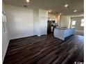 Living room with hardwood floors leading to stainless steel appliances and island at 645 Castillo Dr., Loris, SC 29569