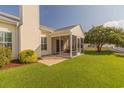 Expansive backyard with a screened porch, patio, and well-maintained lawn at 724 Alexis Dr., Longs, SC 29568