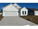 Attractive one-story home featuring a two-car garage, white siding, and a concrete driveway at 791 Wailea Circle, Little River, SC 29566