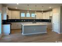 Spacious kitchen with white cabinets, an island, pendant lighting, and stainless steel appliances at 791 Wailea Circle, Little River, SC 29566