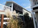 Home exterior showcasing the architectural details and outdoor living space at 829 9Th Ave. S, North Myrtle Beach, SC 29582