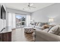 Comfortable living room with neutral tones, balcony access, and stylish nautical patterned accents at 1017 World Tour Blvd. # 206, Myrtle Beach, SC 29579