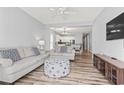 Spacious living room with open layout to dining area, neutral décor, and laminate flooring at 1017 World Tour Blvd. # 206, Myrtle Beach, SC 29579
