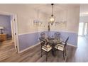 Inviting dining area with a glass table, decorative lighting, and calming wall colors at 1058 Sea Mountain Hwy. # 14-203, North Myrtle Beach, SC 29582
