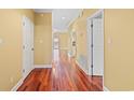 Inviting hallway with pristine white doors and rich hardwood flooring throughout at 1335 Hidden Harbor Rd., Myrtle Beach, SC 29577
