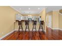 Open concept view of kitchen featuring barstool seating and hardwood floors at 1335 Hidden Harbor Rd., Myrtle Beach, SC 29577