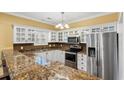 Stylish kitchen featuring granite countertops, stainless steel appliances, and glass-front cabinets at 1335 Hidden Harbor Rd., Myrtle Beach, SC 29577