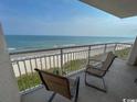 Relaxing balcony view with chairs overlooking the beach and ocean at 1401 S Ocean Blvd. S # 1003, North Myrtle Beach, SC 29582