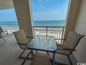 Wonderful balcony view with seating overlooking a long beautiful sandy beach at 1401 S Ocean Blvd. S # 1003, North Myrtle Beach, SC 29582