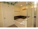 This bright bathroom has a jacuzzi tub, shower, and beachy ceiling at 1625 S Ocean Blvd. # 1109, North Myrtle Beach, SC 29582
