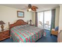 This vibrant bedroom offers a ceiling fan and access to the balcony at 1625 S Ocean Blvd. # 1109, North Myrtle Beach, SC 29582