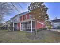 Spacious outdoor screened porch with lawn and landscaping at 1654 Low Country Pl. # F End, Myrtle Beach, SC 29577