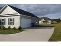 Attached two-car garage with adjacent parking area, complementing the home's exterior at 206 Marley Ct., Conway, SC 29526
