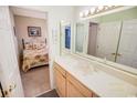 Bathroom that adjoins the bedroom, featuring a light wood vanity with large mirrors at 2203 Sweetwater Blvd. # 2203, Murrells Inlet, SC 29576