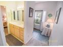 Bright bathroom featuring a light wood vanity and a doorway that leads to the bedroom at 2203 Sweetwater Blvd. # 2203, Murrells Inlet, SC 29576