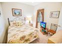 Cozy bedroom with floral bedding, complementing wall art, and a window offering natural light at 2203 Sweetwater Blvd. # 2203, Murrells Inlet, SC 29576