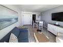 Stylish living room featuring a comfy sofa, a flat-screen TV, and an ocean-themed decor, great for relaxing at 2401 S Ocean Blvd. # 852, Myrtle Beach, SC 29572