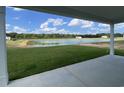 Enjoy stunning water views from this covered back patio with lush green lawn at 242 Letha Dr, Longs, SC 29568