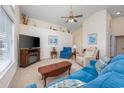 Comfortable living room with plush seating, a ceiling fan, and a cozy fireplace for relaxing evenings at 286 Bonnie Bridge Circle, Myrtle Beach, SC 29579