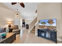 Inviting living room with tile floors, ceiling fan, and an open layout leading to the staircase at 307 River Rock Ln. # 906, Murrells Inlet, SC 29576