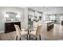 Open-concept dining area adjacent to a modern kitchen with a view into the living area at 438 Myrtle Meadows Dr, Conway, SC 29526