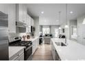 Modern kitchen with stainless steel appliances, white cabinets, and a spacious island with seating at 438 Myrtle Meadows Dr, Conway, SC 29526