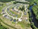 Aerial view of a residential neighborhood featuring manicured lawns and a winding river at 516 Honeyhill Loop, Conway, SC 29526