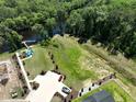 Aerial view of a waterfront property featuring a private dock, pool, and expansive yard at 516 Honeyhill Loop, Conway, SC 29526