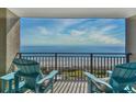 Relaxing ocean view from the condo balcony, furnished with blue Adirondack chairs to enjoy the scenery at 5523 N Ocean Blvd. # 1513, Myrtle Beach, SC 29577