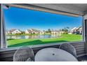 Relaxing screened porch view overlooking a picturesque lake and lush green landscape at 592 Riverward Dr. # 592, Myrtle Beach, SC 29588