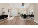 Bright foyer and dining area featuring hardwood floors, chandelier and natural light at 598 Summer Green Ct., Sunset Beach, NC 28468