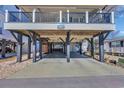 Home featuring ample covered parking and storage space beneath the elevated structure of the house at 6001-5126 S Kings Hwy., Myrtle Beach, SC 29575