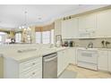 Bright kitchen featuring white cabinetry, and modern appliances at 63 Mckissick Dr. # 2B, Pawleys Island, SC 29585